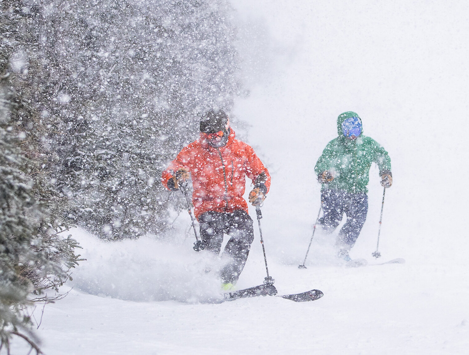 Two skiers in falling snow