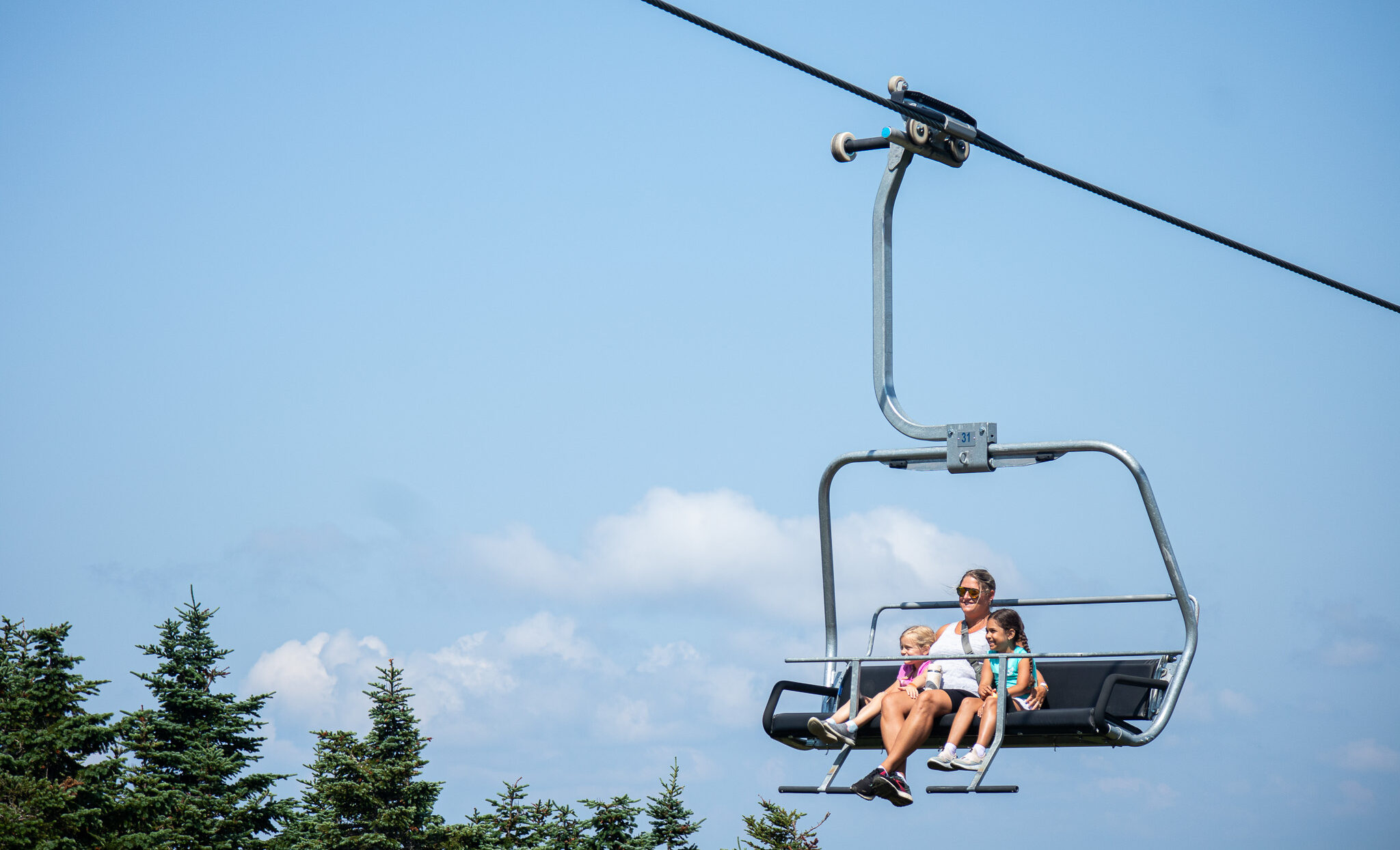 Parent and two children on the Rangeley Quad - summer scenic lift ride